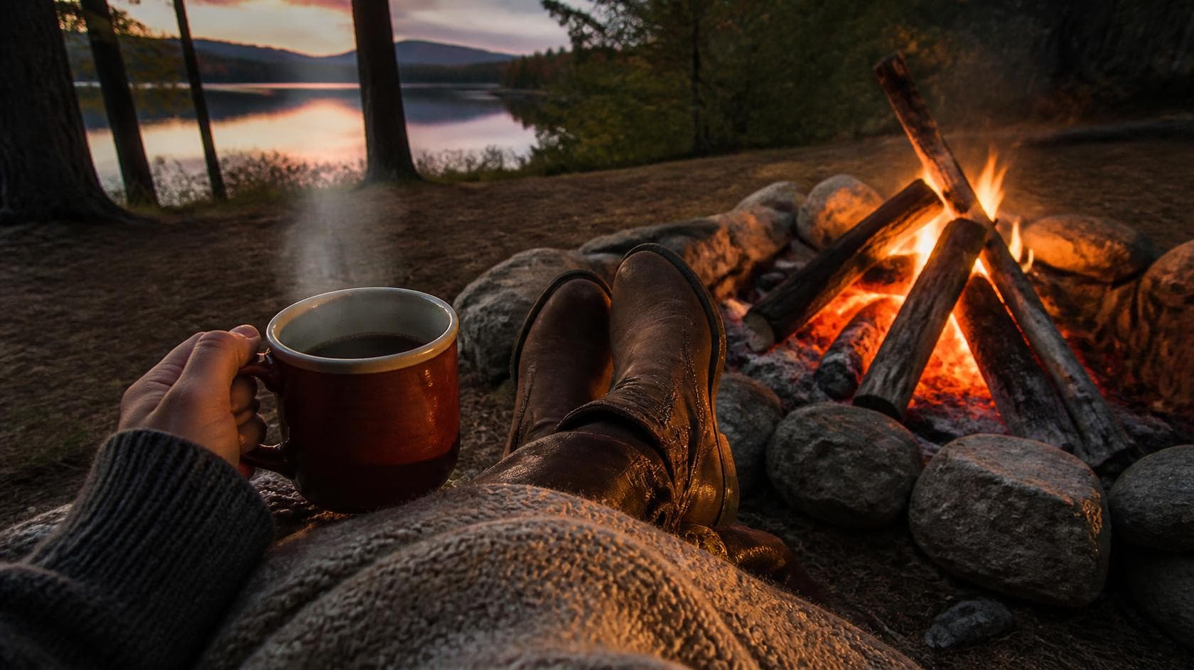 Campfire view with warm coffee mug